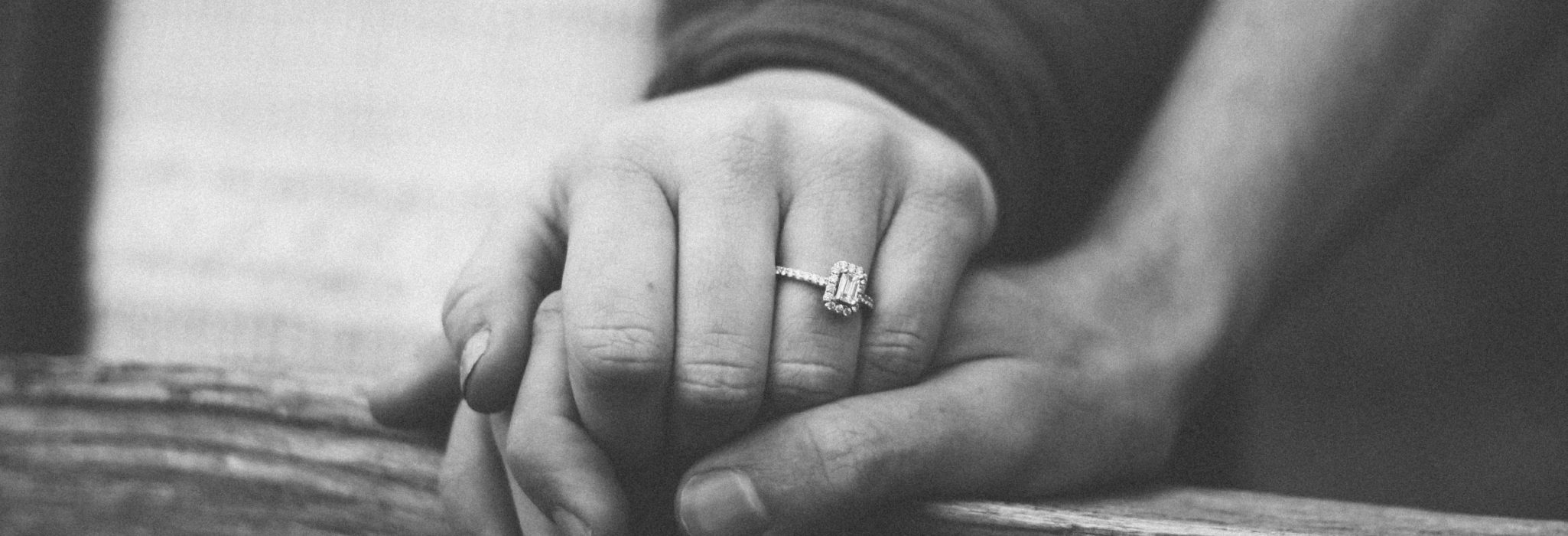 couple-holding-hands-wedding-ring